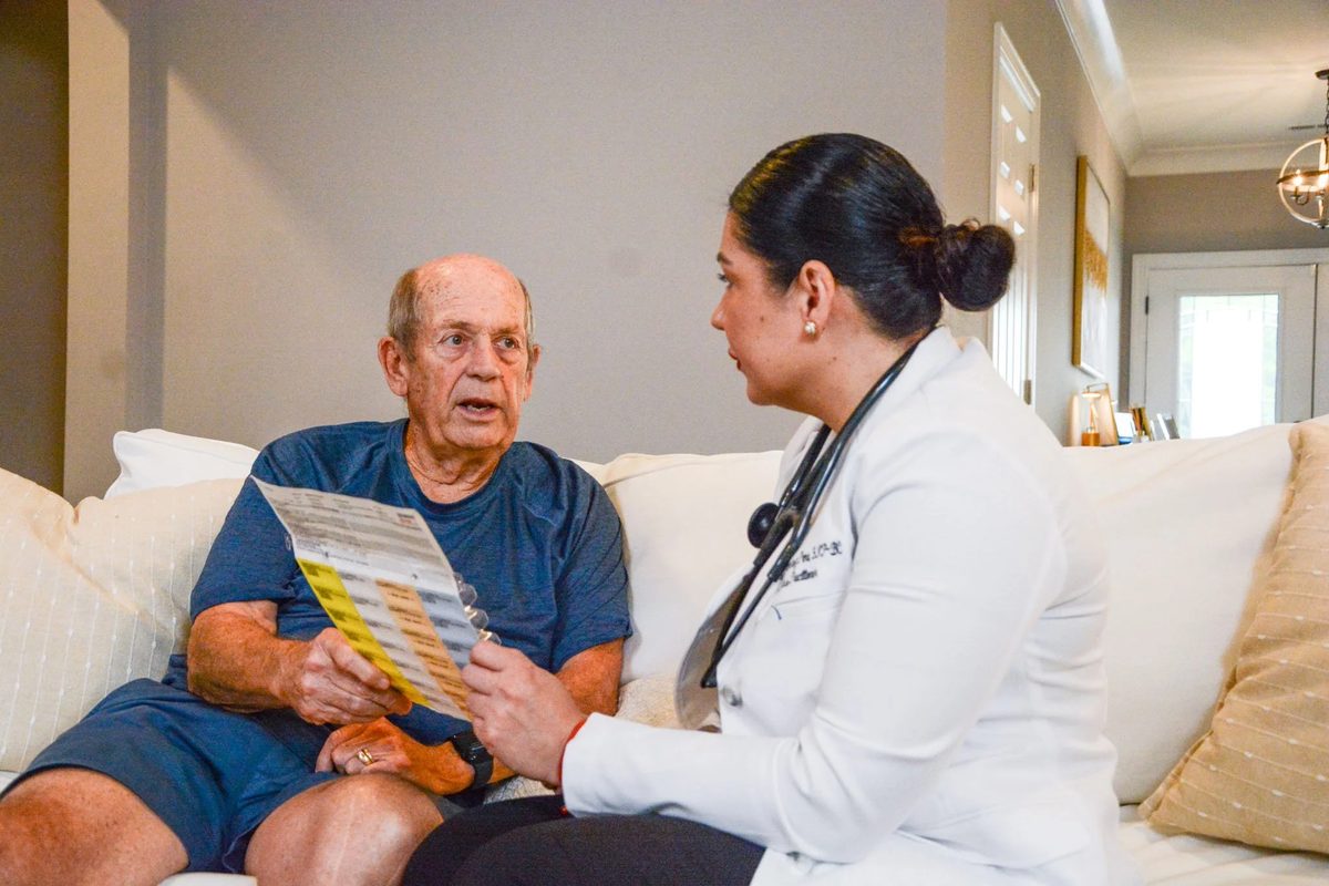 Kidan Medical provider reviewing a patient's medication list during a chronic care visit