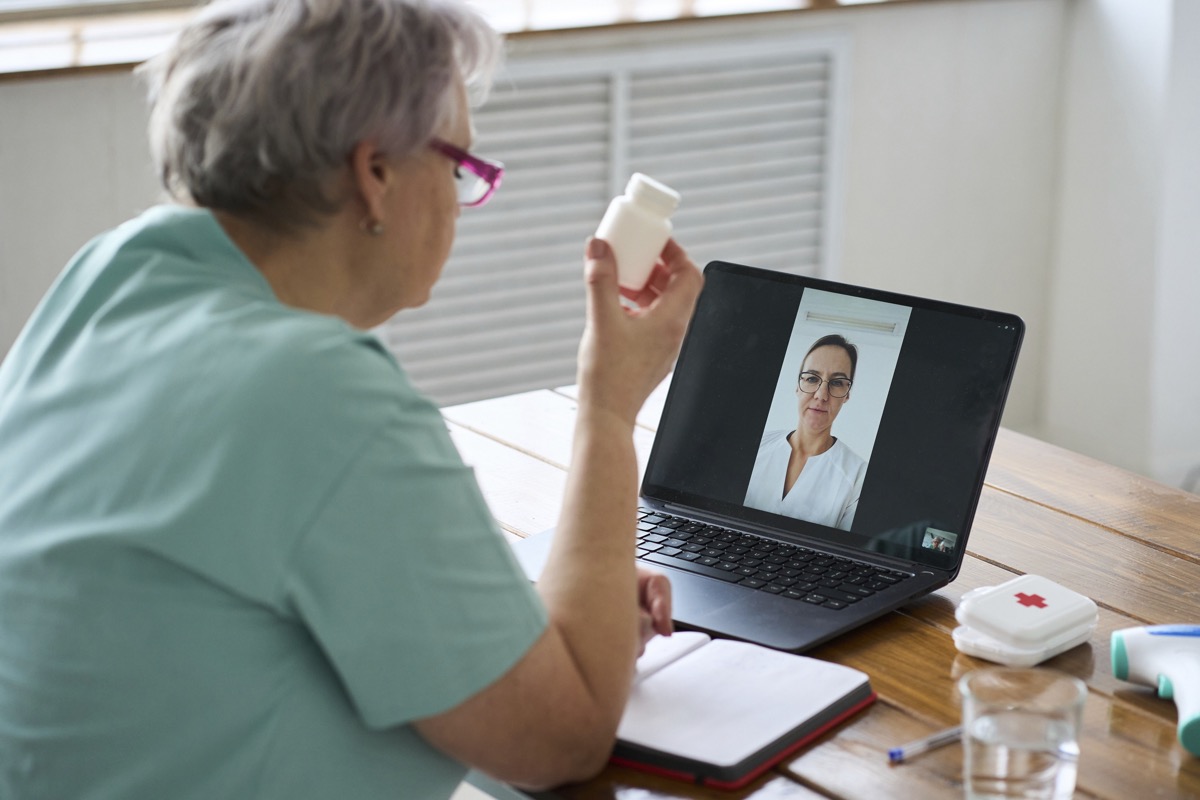 Patient reviewing paperwork before a telehealth visit from home