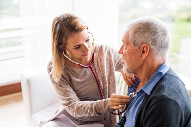 Kidan Medical provider examining a patient during a home visit